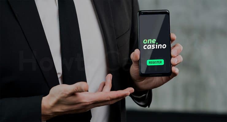 Man holding mobile with One Casino registration button